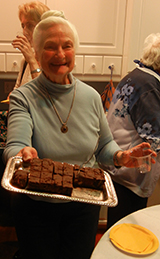 Nan Davies offering brownies after a 2015 Guild meeting
